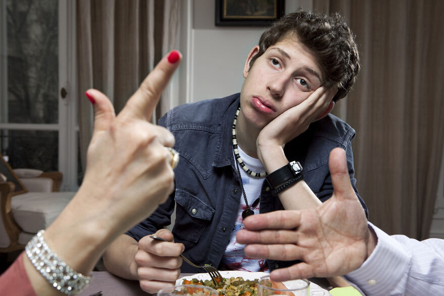 Teen looking like the outcast during a family argument at dinner, highlighting struggles outside family narrative.