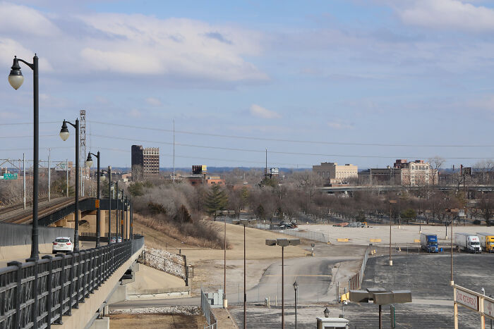 Urban industrial area with empty lots and sparse vegetation, representing one of the worst places in the US visited by people.