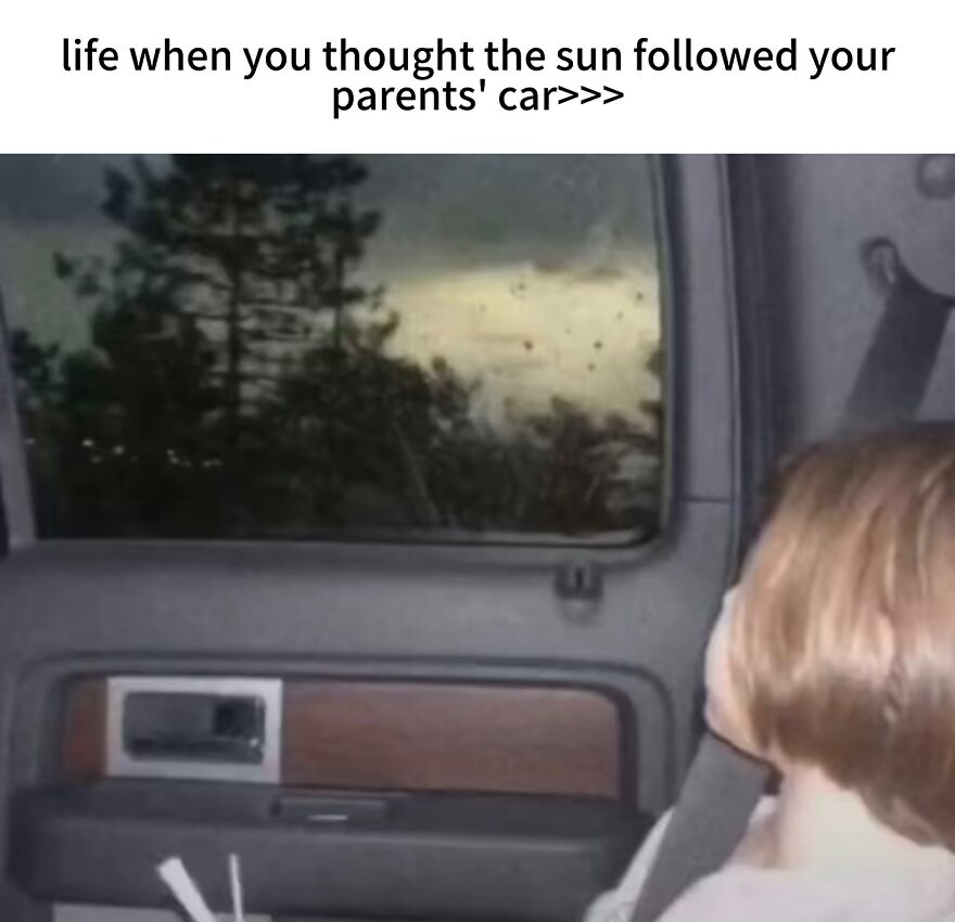 A child gazing out a car window, thinking the sun followed their parents car. A nostalgic photo of growing up in the 2000s.