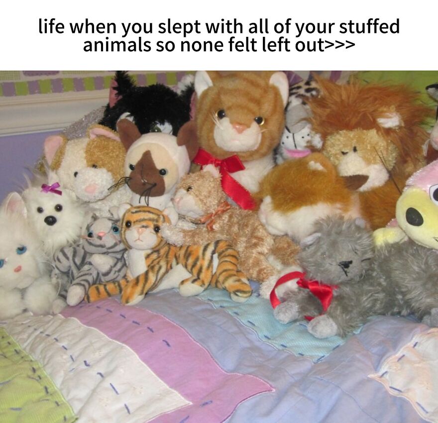 A collection of stuffed animals, including cats, a tiger, and a lion, packed onto a bed. Nostalgic photos from the 2000s.