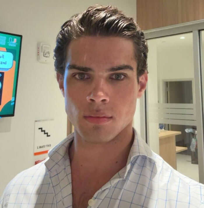 Young man in a checkered shirt at a hospital, connected to clavicular injury after livestream incident.