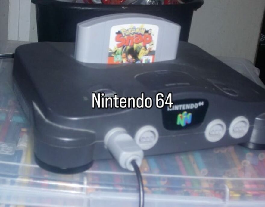 A classic Nintendo 64 console with a Pokémon Snap cartridge, capturing the nostalgic vibe of growing up in the 2000s.