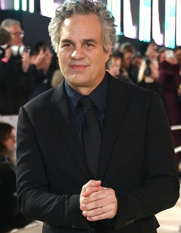 Mark Ruffalo at a public event, dressed in a black suit, surrounded by photographers and fans. Mark Ruffalo at a public event, dressed in a black suit, surrounded by photographers and fans.