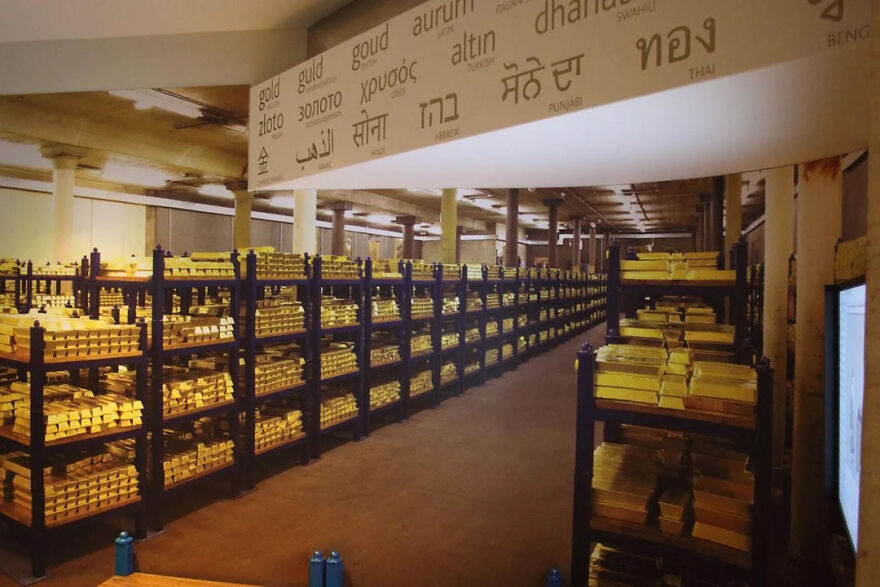 A vast vault filled with countless gold bars on shelves, showcasing impressive security for this off-limits place.