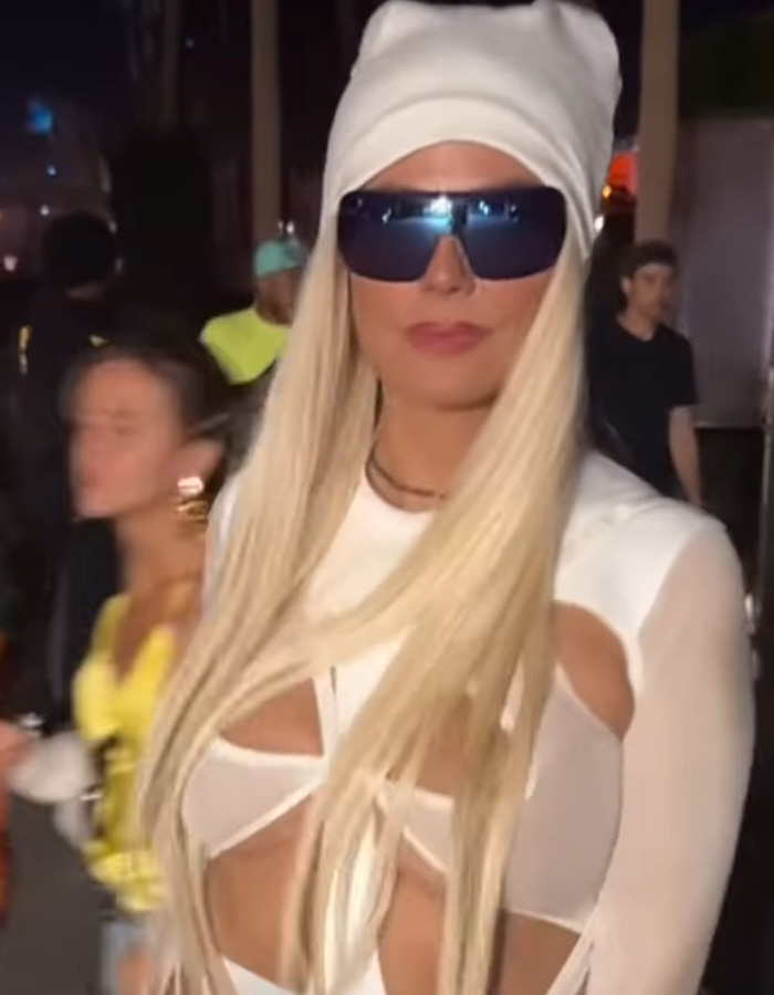 Heidi Klum at Coachella 2026 wearing a striking white outfit, long blonde hair, oversized sunglasses, and a white head wrap.