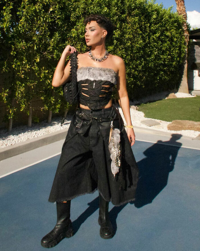 Person in a black cut-out top and wide black pants showcasing Coachella 2026 fashion fails and absurd looks outdoors.