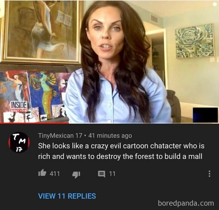 Woman in a blue shirt with a comment below her video: "She looks like a crazy evil cartoon character". This is a rare burn.