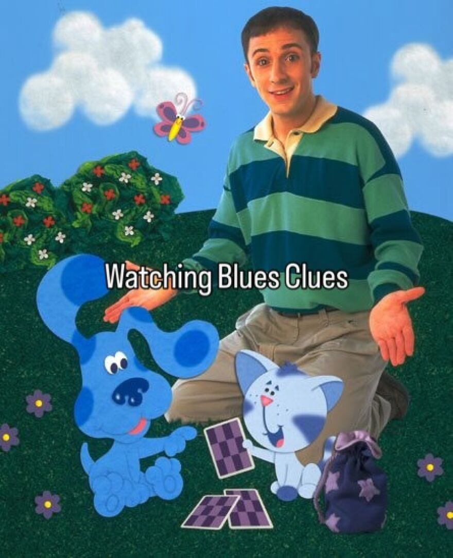 A man in a striped shirt kneels beside cartoon Blue from Blue's Clues and a cat, representing 2000s nostalgia.