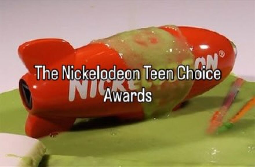 A red Nickelodeon Kids Choice Awards blimp covered in green slime, capturing the vibe of growing up in the 2000s.
