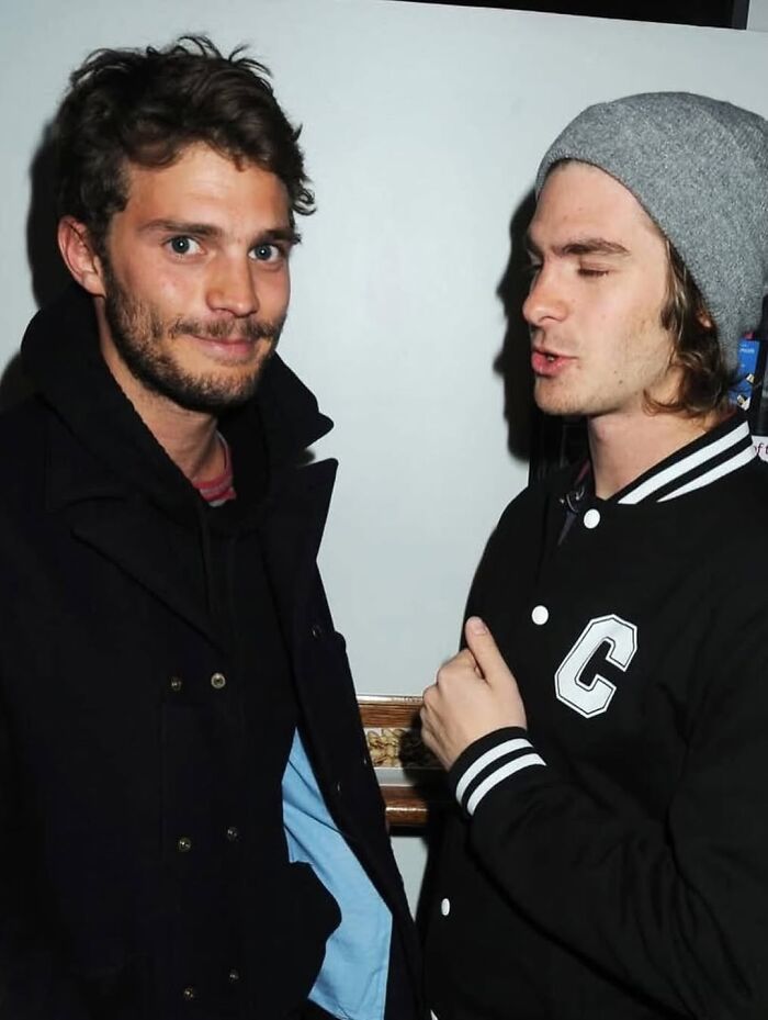 Two male celebrities sharing candid moment