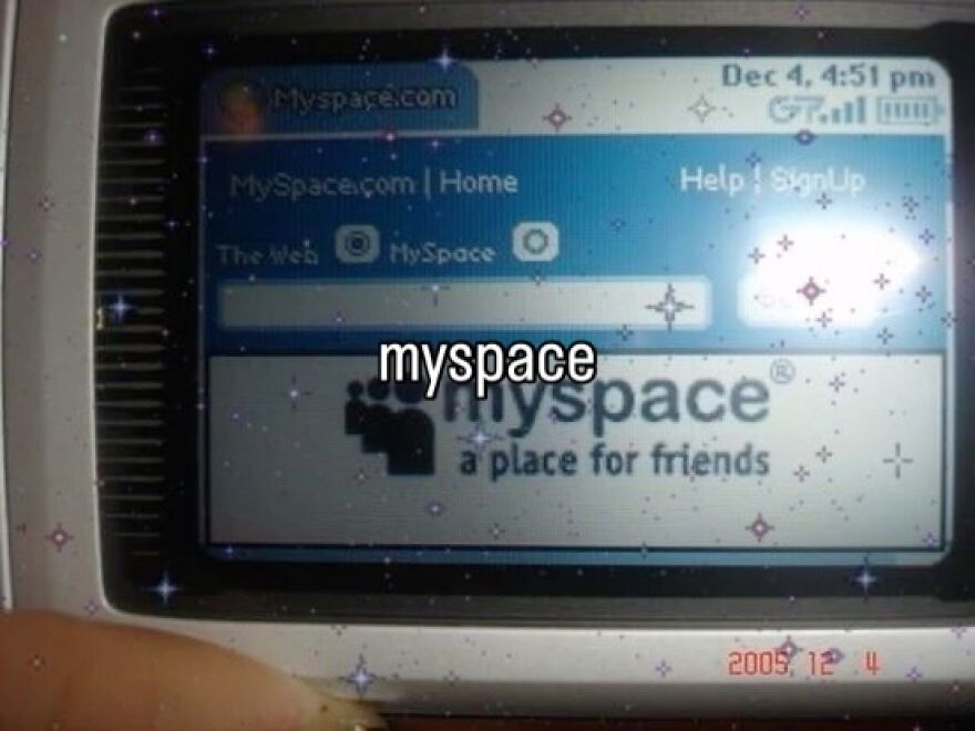 A close-up of a flip phone displaying the Myspace login page, capturing the vibe of growing up in the 2000s.