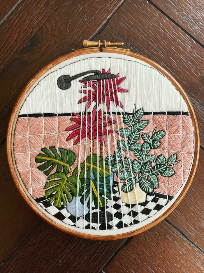 An intricate embroidery creation depicting potted plants under a shower in a tiled bathroom, inspiring new hobbies.