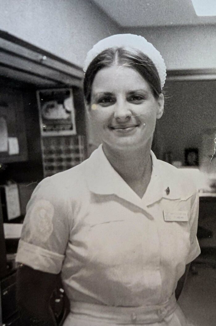 Candid old photo of a smiling nurse in uniform, revealing what the world looked like generations ago.