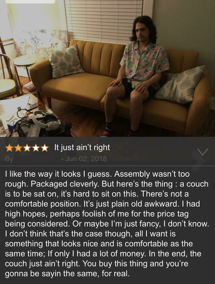 Man sitting on a mustard yellow couch in a casual shirt with a humorous Amazon eyeliner review overlay.