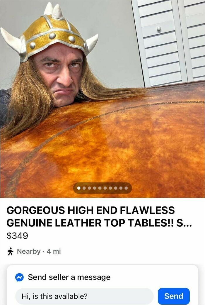 Man wearing a horned helmet showing a bizarre leather top table listing in an online marketplace.