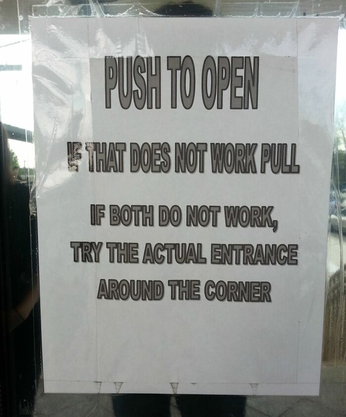 Funny pieces of advice on a sign with instructions to push, pull, or find the actual entrance around the corner.