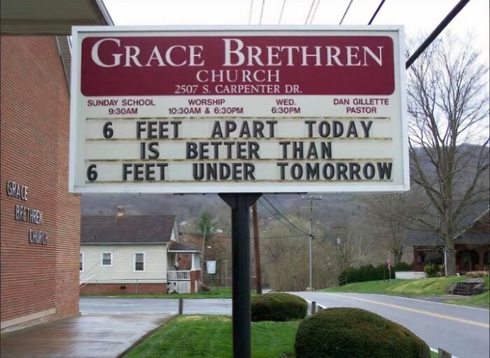 Church sign displaying funny pieces of advice about social distancing with humor in a suburban neighborhood setting.