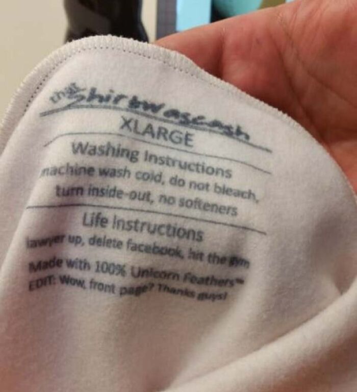 Close-up of a humorous shirt label showing funny pieces of advice with washing and life instructions on fabric.