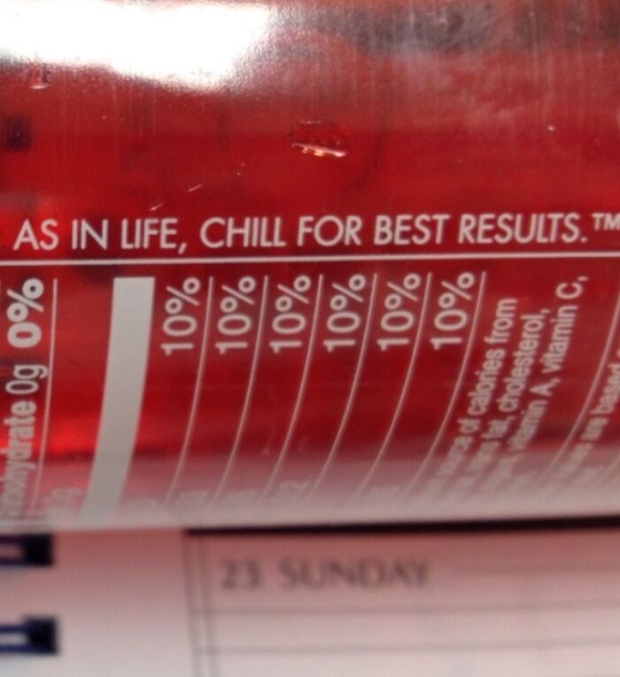 Close-up of a red can with nutrition facts and funny advice text about chilling for best results, humor and fun concept.
