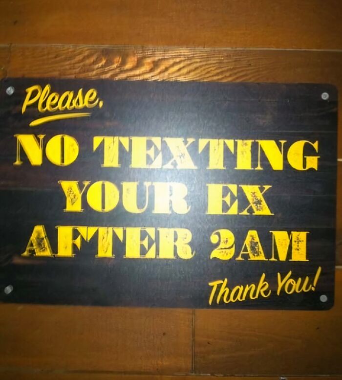 Humorous advice sign warning against texting your ex after 2 AM, reflecting funny pieces of advice and tips.