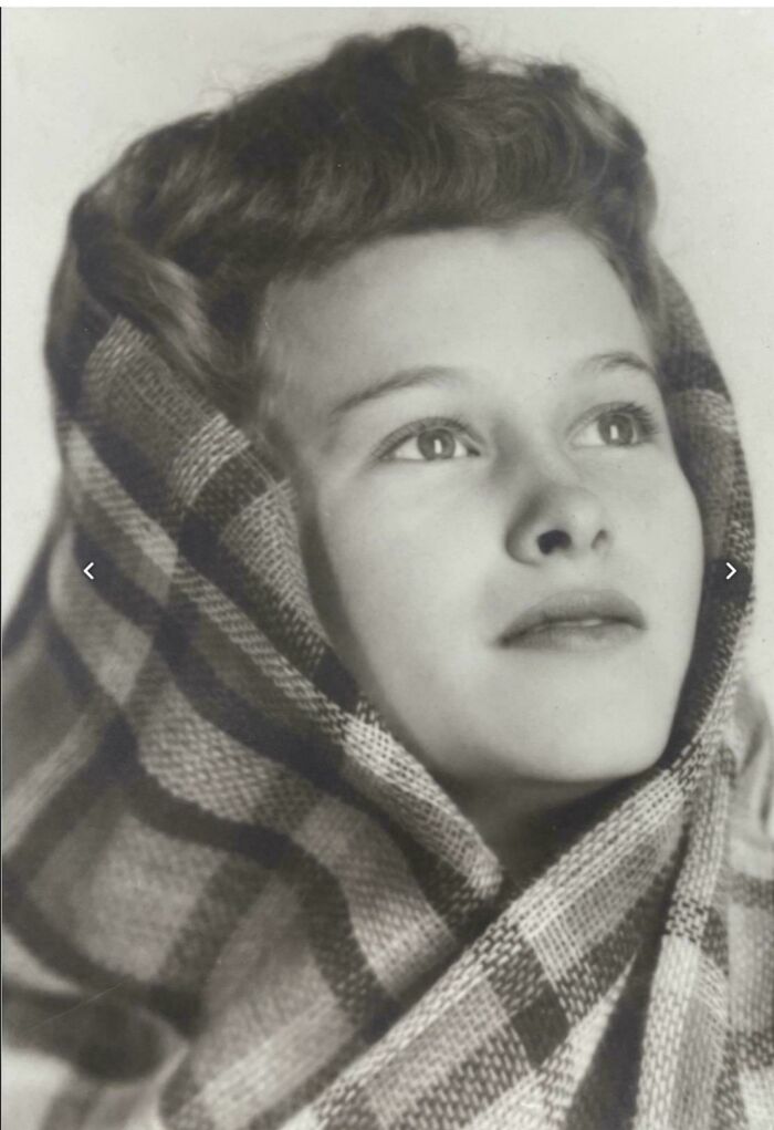 Candid old photo of a young woman wrapped in a plaid shawl, revealing what the world looked like generations ago.