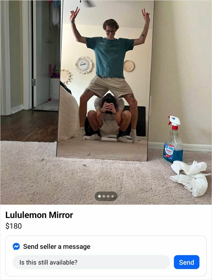 Two people pulling off a creative pose in front of a Lululemon mirror with cleaning spray on the floor nearby.