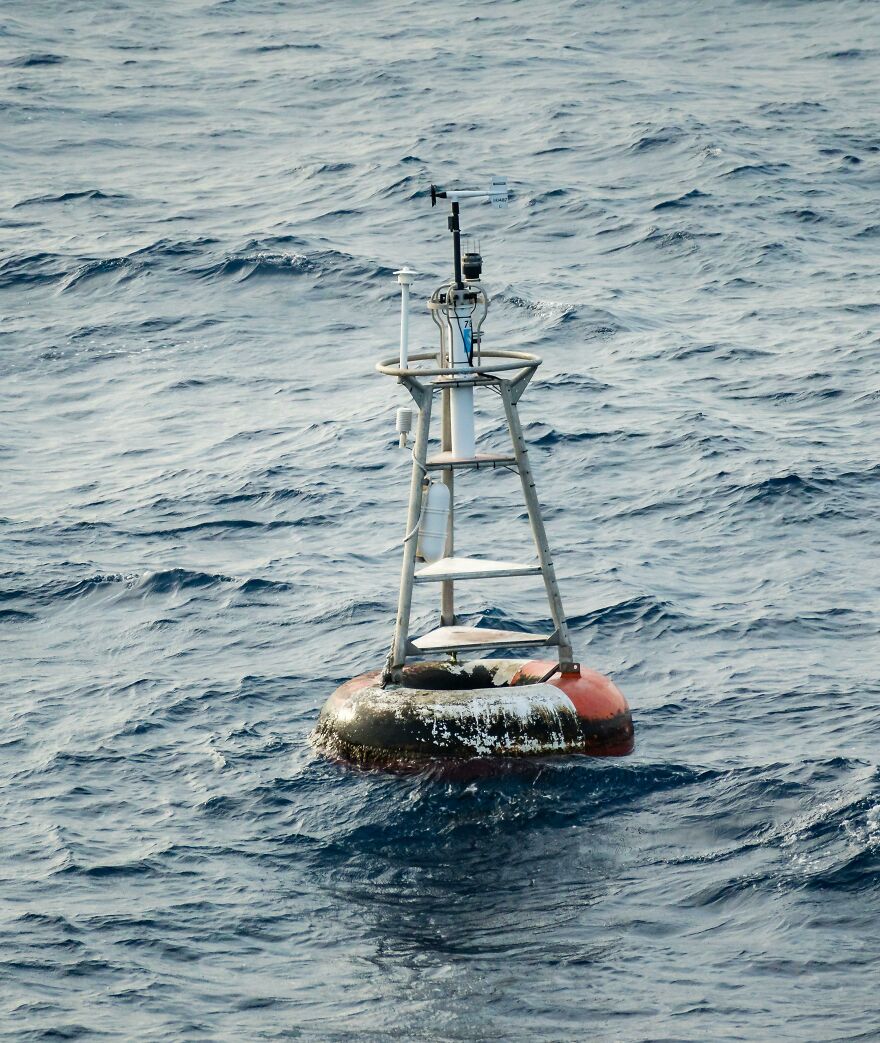 Ocean buoy floating on wavy water, a visual representing interesting and fun facts about ocean technology and science.