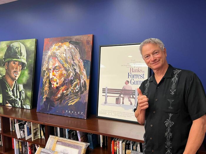 Man giving thumbs up standing next to paintings and a Forrest Gump poster, illustrating moments from the year you were born.