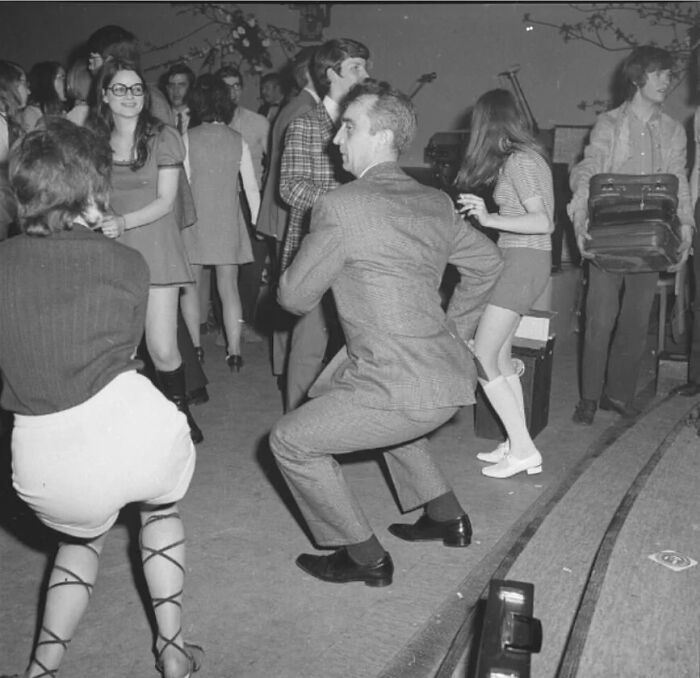 Candid old photo of people dancing at a party, revealing what the world looked like generations ago.