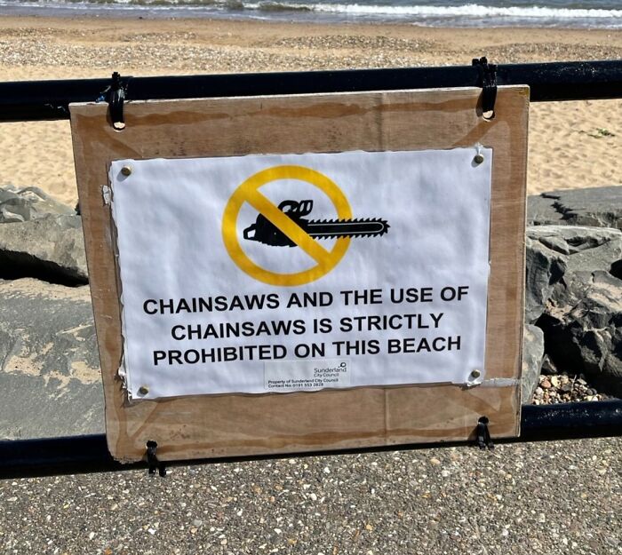 Beach sign prohibiting chainsaws, a surprisingly specific rule. This highlights odd rules that make you wonder who inspired them.