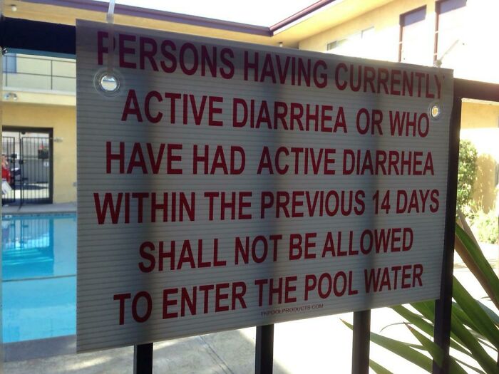 A pool sign with specific rules, stating no entry with active diarrhea. An example of oddly specific rules, not mentioning underwear must be worn.