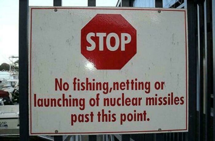 A stop sign warns no fishing, netting, or launching nuclear missiles. An example of oddly specific rules.