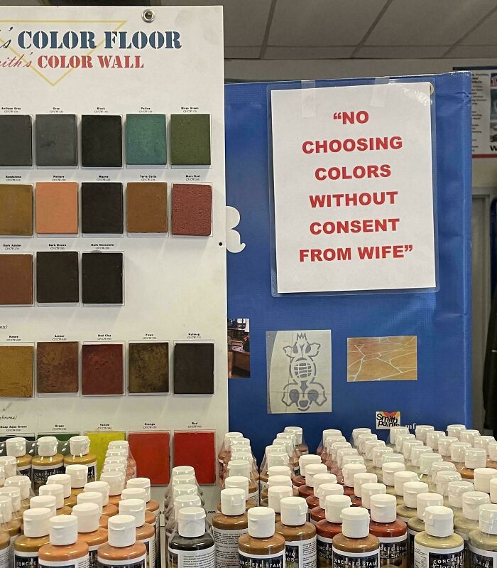 Display of concrete stains and a sign stating, "NO CHOOSING COLORS WITHOUT CONSENT FROM WIFE." An oddly specific rule.