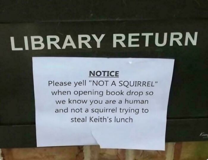 An oddly specific rule notice on a library return box to yell "NOT A SQUIRREL" to avoid stealing Keith's lunch.