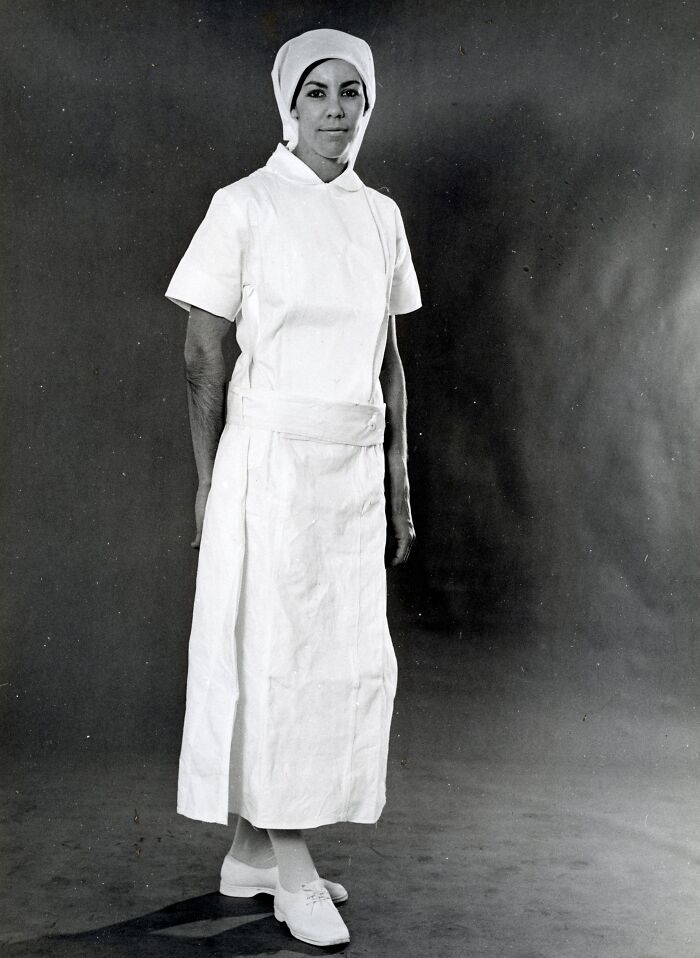 Black and white photo of a woman in vintage nurse uniform, showcasing rare and interesting photos from a past time.