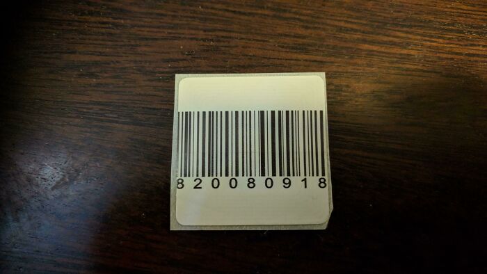 Barcode label placed on a dark wooden surface showing clever use of everyday items displaying intelligence.
