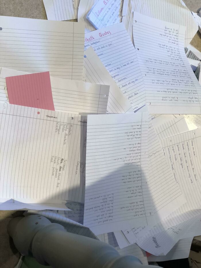 Scattered handwritten notes and papers found in an elevator pit, showing unusual and disturbing contents.