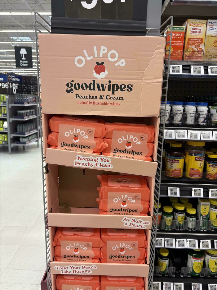 An OLIPOP Goodwipes display in a store aisle, illustrating product marketing and consumerism.