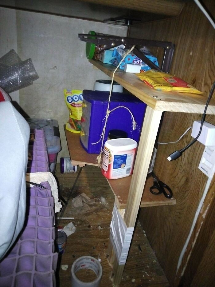 A small, cluttered space with shelves and items, showcasing random junk turned into storage solutions.