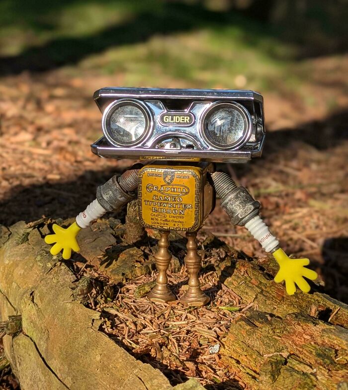 Whimsical robot sculpture made from vintage binoculars and an old tin, a truly unique handmade project.