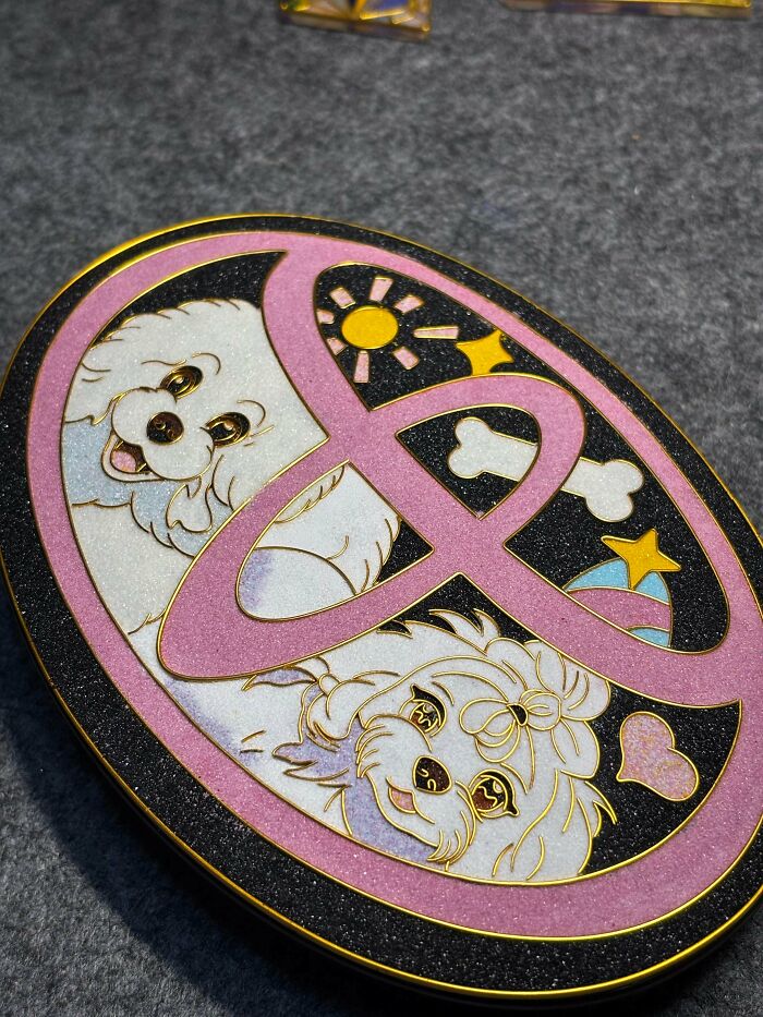 Oval enamel pin with two cute dogs and playful elements, a charming handmade project with great talent.
