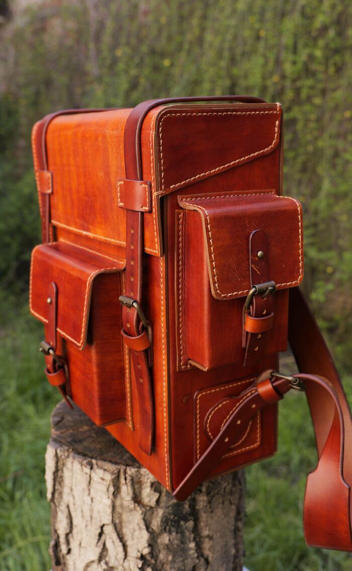 Detailed, rustic leather messenger bag with multiple pockets, a prime example of a handmade project.