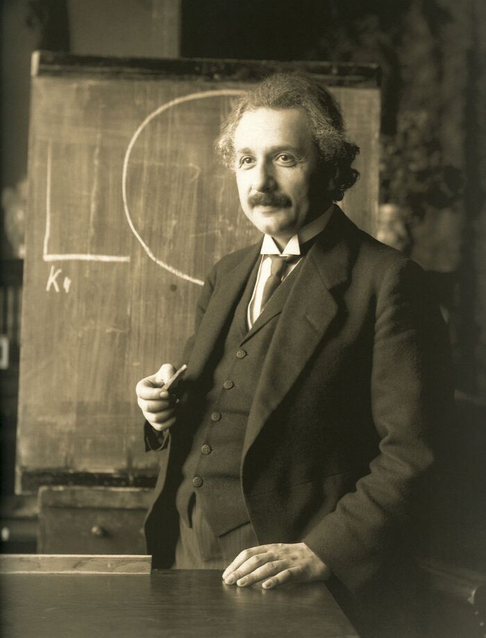 Vintage rare photo of a man standing by a chalkboard with scientific drawings from a time we will never experience.