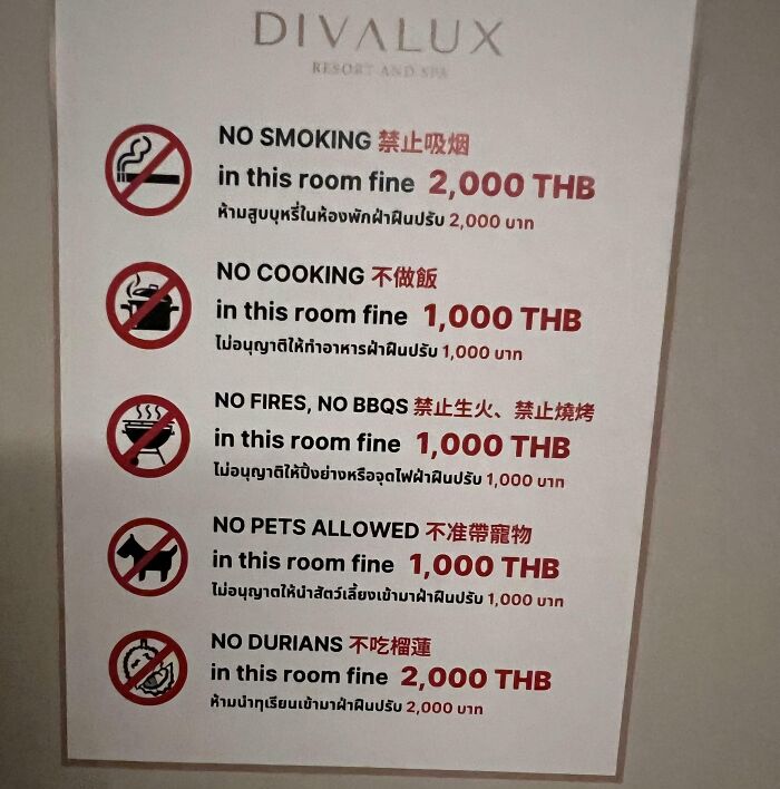 A Divalux Resort and Spa sign listing oddly specific rules like no smoking, cooking, fires, pets, or durians.
