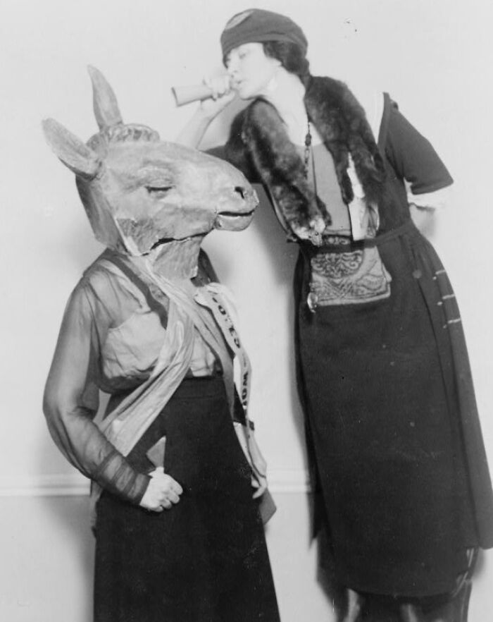 Black and white vintage photo showing two people in rare and interesting costumes from a time we will never experience.