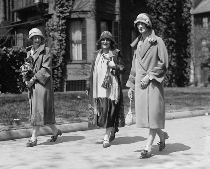 Three women in vintage 1920s clothing walking outside, capturing rare and interesting photos from a past time.