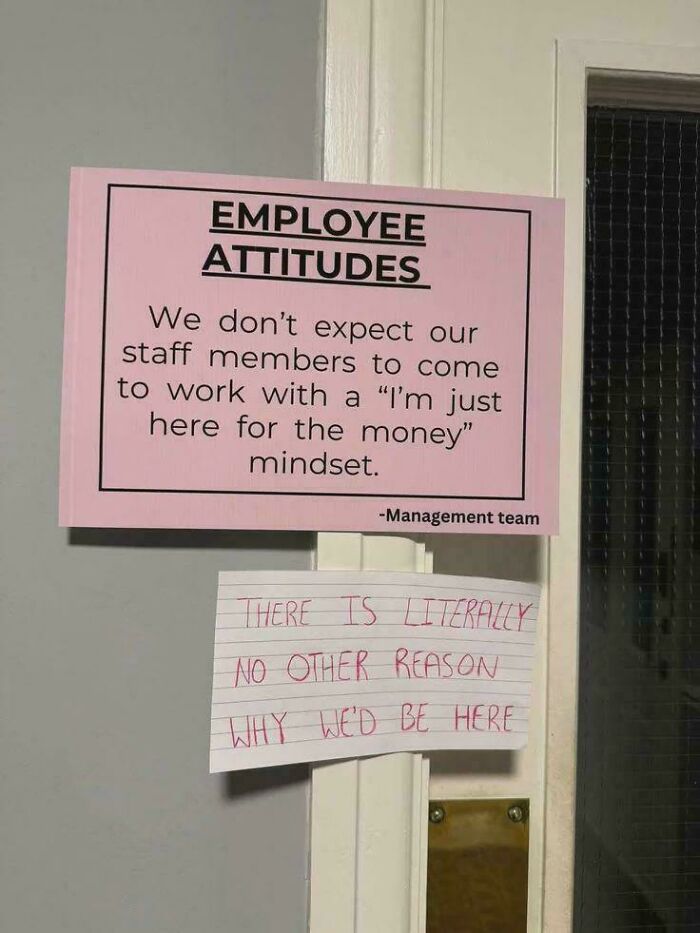 A pink sign about employee attitudes with a handwritten note below, depicting a chaotic good moment.