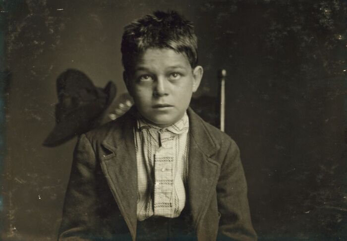 Vintage portrait of a young boy in old-fashioned clothing, one of the rare and interesting photos from a past era.