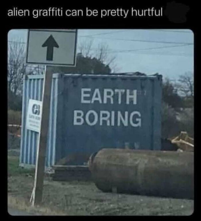 Graffiti on a container reading Earth Boring with a signpost and outdoor industrial setting, a lighthearted safe-for-work meme.