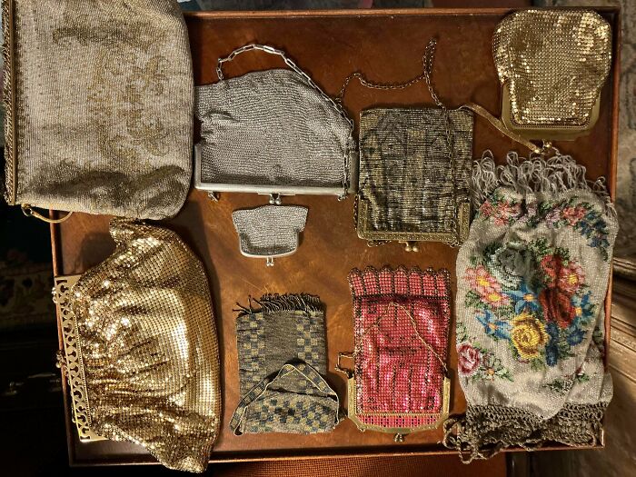 A collection of remarkable antique purses and handbags in various styles and materials, showcasing historical fashion.